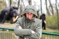 portrait of expressive middle aged man posing in front of mammoth models in a public park Royalty Free Stock Photo