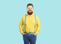 Portrait of extravagant confident and stylish chubby man on light blue background.