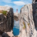 Portrait of a extreme plan travel for the girl on the stone of the kjerag in the mountains of Norway, the feeling of