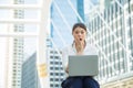 Portrait Extremely excited young Asian beautiful woman in casual white shirt is sitting on floor looking at laptop on her lap,