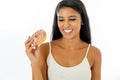 Portrait of extremely happy beautiful latin young woman eating a delicious donuts enjoying it with pleasure in give yourself a Royalty Free Stock Photo
