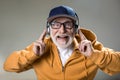 Modern pensioner listening to music from headphones