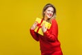 Portrait of extremely happy woman with red lipstick in bright casual sweater, isolated on yellow background