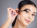 Portrait, eyelash and brush for makeup, mascara and beauty with girl with grey studio background. Face, eyes and salon