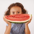Portrait, eyes or girl with watermelon in studio for healthy, diet or wellness on grey background. Fruit, hiding or kid Royalty Free Stock Photo