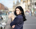 Portrait f beautiful intelligent brunette who walks down street of Saint-Petersburg in city center. Charming thoughtful woman with