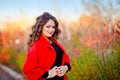 Portrait of a fabulously beautiful girl in a red coat