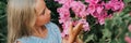 portrait face of candid little kid girl of eight years old on background of green plants and