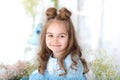 Portrait of face of little beautiful girl with long hair. Closeup portrait of a little smiling girl. March 8, International Women` Royalty Free Stock Photo