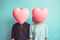 Portrait of faceless couple in love holding pink heart shaped balloons. Valentine& x27;s day concept