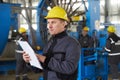 Portrait of factory worker holding paper clipboard Royalty Free Stock Photo