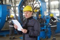 Portrait of factory worker holding paper clipboard Royalty Free Stock Photo