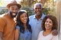 Portrait of Family With Adult Parents With Grown Up Son And Daughter Relaxing In Garden At Home Royalty Free Stock Photo