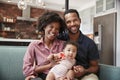 Portrait Of Family With Baby Daughter Relaxing On Sofa At Home Together Royalty Free Stock Photo