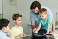 portrait of family cooking breakfast together in kitchen Royalty Free Stock Photo