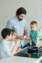 portrait of family cooking breakfast together in kitchen Royalty Free Stock Photo