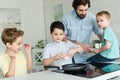 portrait of family cooking eggs for breakfast together in kitchen Royalty Free Stock Photo