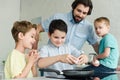 portrait of family cooking eggs for breakfast together in kitchen Royalty Free Stock Photo