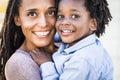 Portrait of family couple mother and son black afro ethnic race smile and look at the camera - concept of diversity and single mom