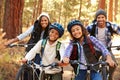 Portrait Of Family Cycling Through Fall Woodland Royalty Free Stock Photo