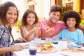 Portrait Of Family Eating Meal At Outdoor Restaurant Royalty Free Stock Photo