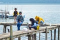 Portrait Of A Family Enjoying A Fishing Trip By The Mountain Lake