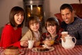 Portrait Of Family Enjoying Tea And Cake Royalty Free Stock Photo