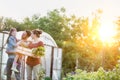 Portrait of a family of famers carrying their vegetables home in wooden boxes, at the end of the day, the Father is carrying their Royalty Free Stock Photo