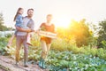 Portrait of a family of famers carrying their vegetables home in wooden boxes, at the end of the day, the Father is carrying their Royalty Free Stock Photo