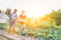 Portrait of a family of famers carrying their vegetables home in wooden boxes, at the end of the day, the Father is carrying their Royalty Free Stock Photo