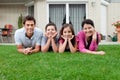 Portrait of family of four lying in backyard Royalty Free Stock Photo