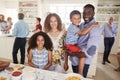 Portrait Of Family With Friends In Kitchen For Multi-Generation Party Royalty Free Stock Photo