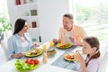 Portrait of family harmony parents chatting daughter drink juice eat healthy domestic dish modern kitchen flat indoors Royalty Free Stock Photo