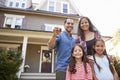 Portrait Of Family Holding Keys To New Home On Moving In Day Royalty Free Stock Photo