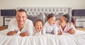 Portrait of family in home bedroom, young kids smile on bed and mother laughing with girl baby happiness. Face of happy Royalty Free Stock Photo