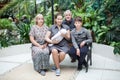 Portrait of family from mother with newborn baby and preteen son, grandparents. Sitting together on bench Royalty Free Stock Photo