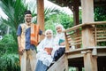 family muslim sitting in the garden and having a conversation