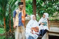 family muslim sitting in the garden and having a conversation