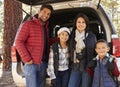 Portrait family outdoors standing at the open back of car Royalty Free Stock Photo