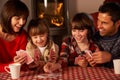 Portrait Of Family Playing Cards By Cosy Log Fire Royalty Free Stock Photo