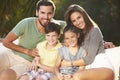 Portrait Of Family Sitting In Garden Together Royalty Free Stock Photo