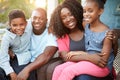 Portrait Of Family Sitting Outside House Royalty Free Stock Photo