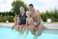 Portrait of family sitting by the pool Royalty Free Stock Photo