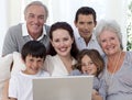 Portrait of family sitting on sofa using a laptop Royalty Free Stock Photo