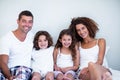 Portrait of a family sitting together on bed Royalty Free Stock Photo