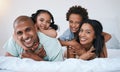 Portrait, family and smile in home bedroom, bonding and relaxing or lying together. Bed, happiness and children with Royalty Free Stock Photo