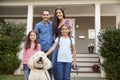 Portrait Of Family Standing in Front Of House With Pet Dog Royalty Free Stock Photo