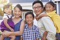 Portrait Of Family Standing Outside House