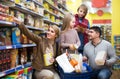 Portrait of family with two children in local supermarket