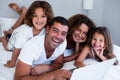 Portrait of family using laptop together on bed Royalty Free Stock Photo